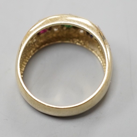 A modern 375 yellow metal and four colour cubic zirconia set dress ring, size O, gross weight 4.6 grams.
